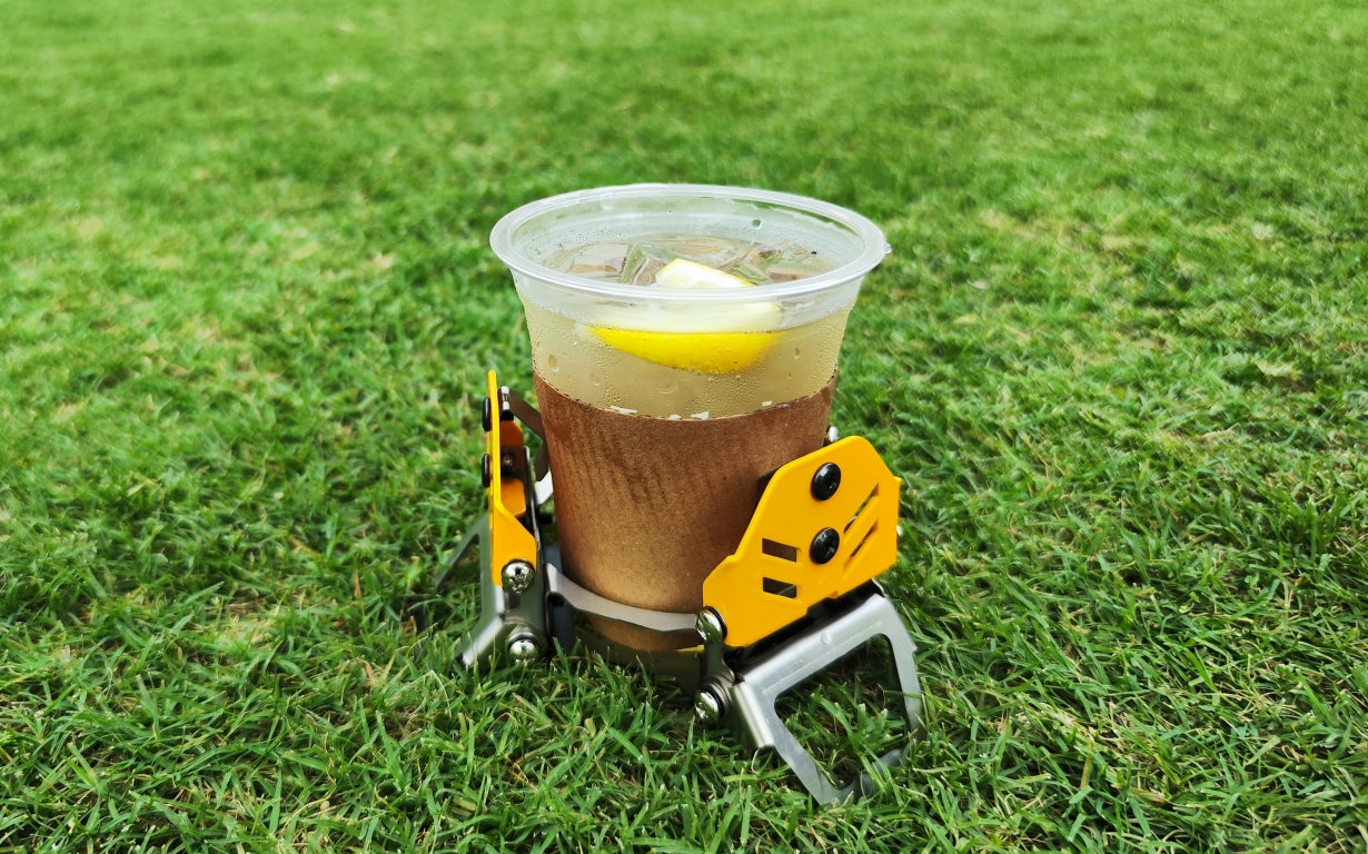 テーブルがなくても飲み物を安定して地面に置ける、折り畳み式ドリンクホルダー